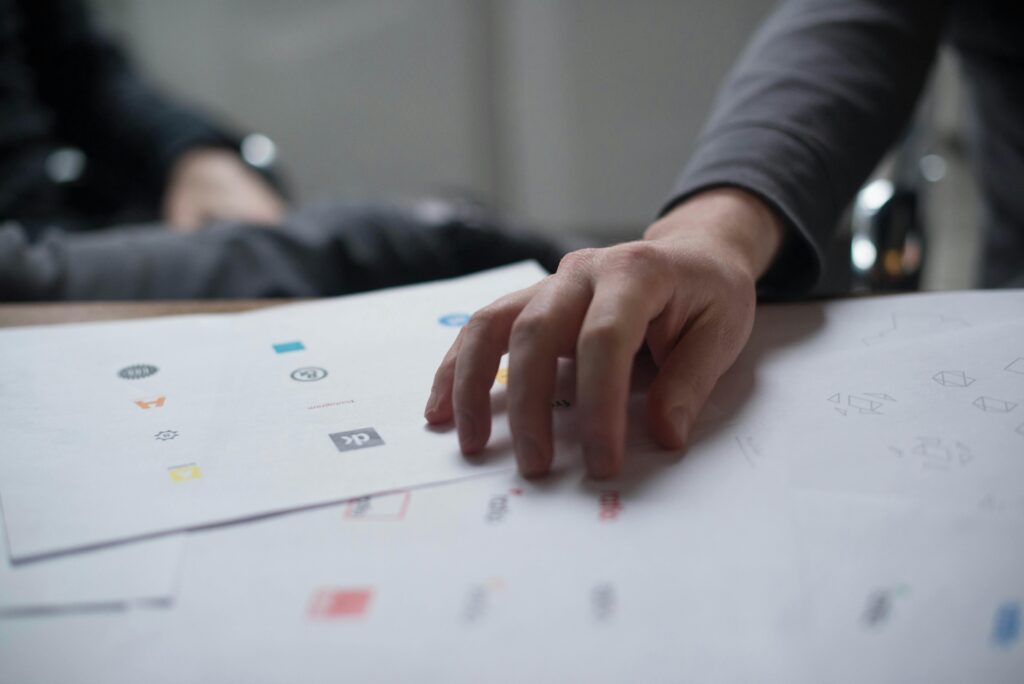 A disheveled stack of papers with printed logos on them.